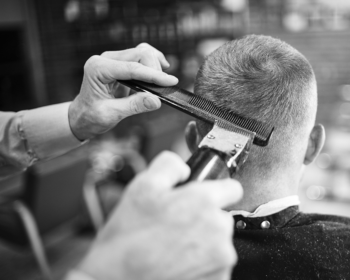 Barber shaving men hair and beard